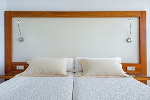 A double bed with a wooden headboard, two bedside tables, and a plain wall. - Biniamar (Sant Llorenc des Cardassar)