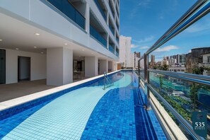 Enjoy a city view from our infinity pool, surrounded by a clean and well-maintained space with a modern design.