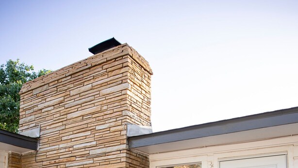 A modern house with a stone exterior, a front porch with a bench, and a door with a window. - New - Spacious 4B2B House in Tech Terrace (Lubbock)