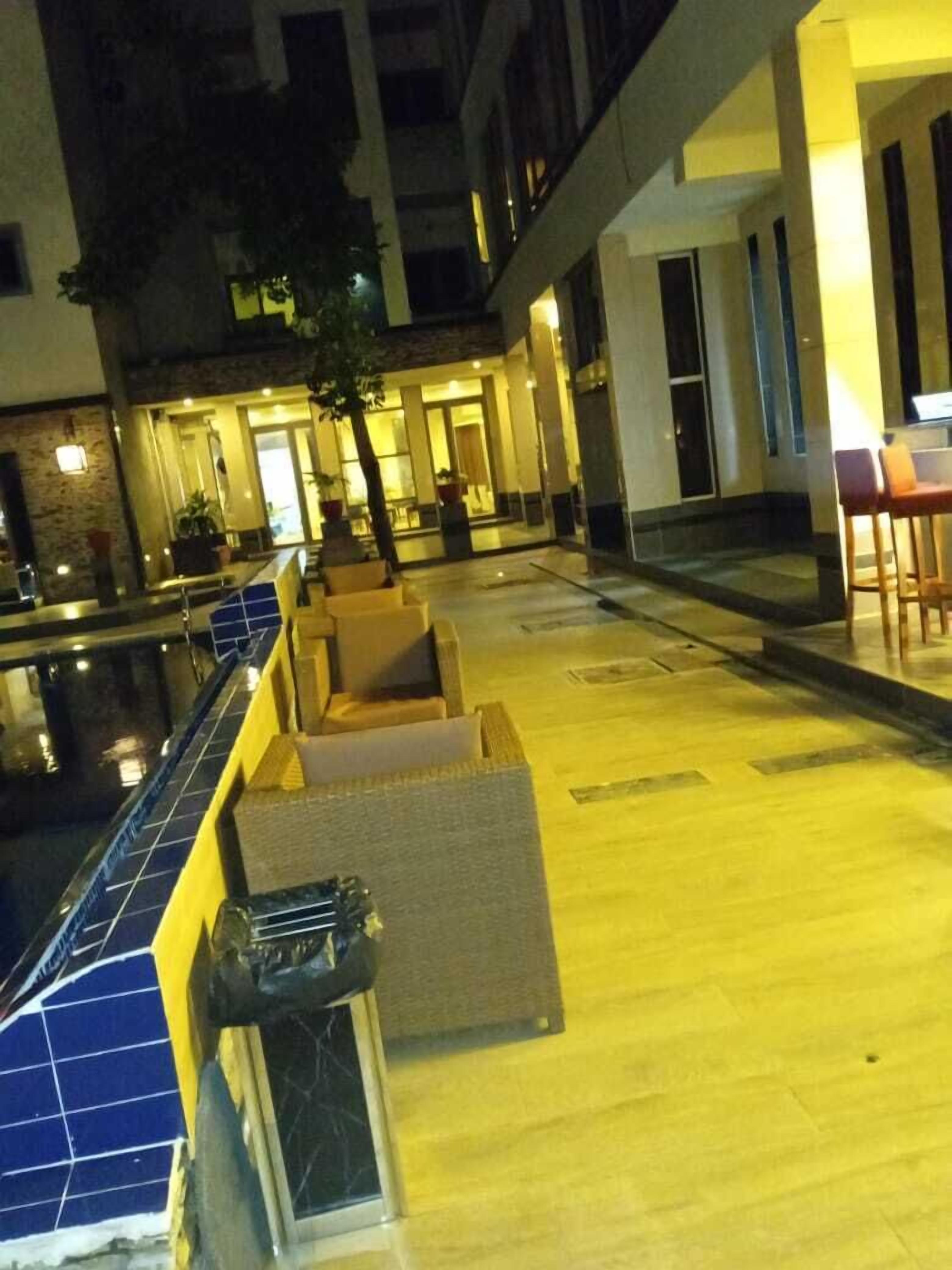 A poolside area with seating and a pool.