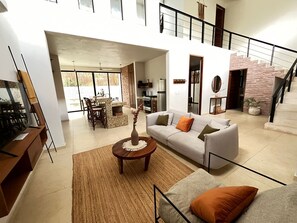Relax in this stylish living area with a sofa, coffee table, and dining space.