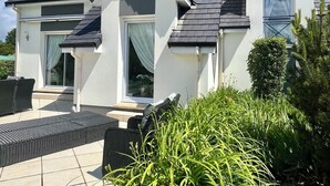 A two-story house with a dark shingled roof, white exterior walls, and a satellite dish. - Villa Campagne Chic (Meulers)