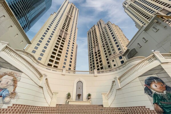 A high-rise building with multiple floors, large windows, and a central atrium.