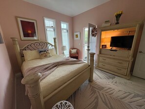 A bedroom with a bed, dresser, and television. - The Tree Top Terrace- is private, close to ocean & downtown on James Island.. (Charleston)