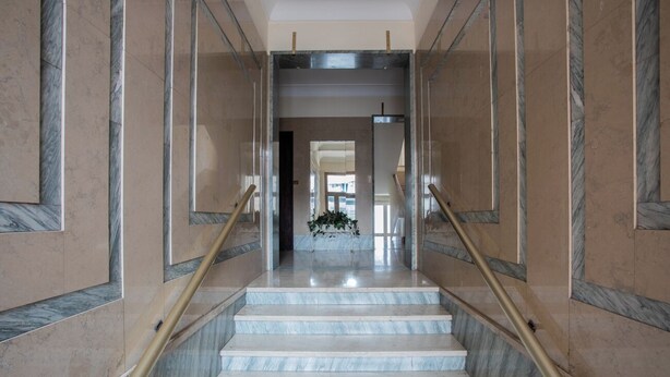 A marble staircase with gold handrails leading to a landing. - Sulla via del treno by Wonderful Italy (Turin)