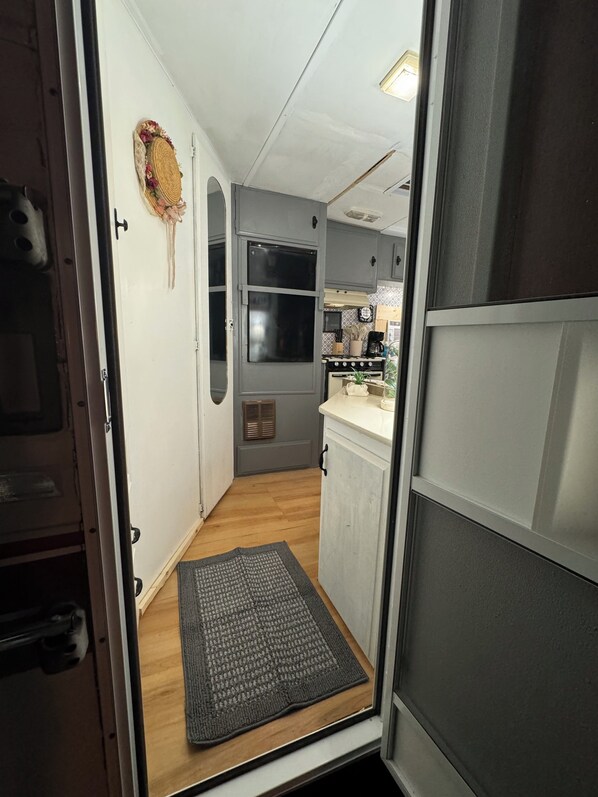 A compact kitchen with a refrigerator, stove, and sink. - Vintage Vibes: Quaint Camper Escape (Versailles)