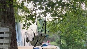A wooden deck with a blue slide. - TreeFort, ZipLine, Kayaks, Beach6min drive, Vaulted Ceilings, ScreenPorch & Deck (Narragansett)
