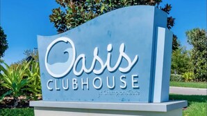 A sign for Oasis Clubhouse at ChampionsGate.