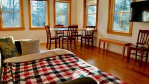 A bedroom with a bed, a desk, and a TV. - Peaceful private location, cottage @Acadia NP, Lighthouse, Beaches, Seafood🦞 (Bass Harbor)