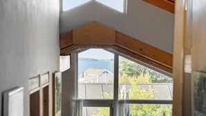 A room with a large window offering a view of a body of water and a distant shoreline. - 3 bedroom beautiful home in Kalundborg (Kalundborg)