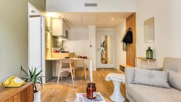 A compact living space with a kitchenette, a dining area, and a seating area.