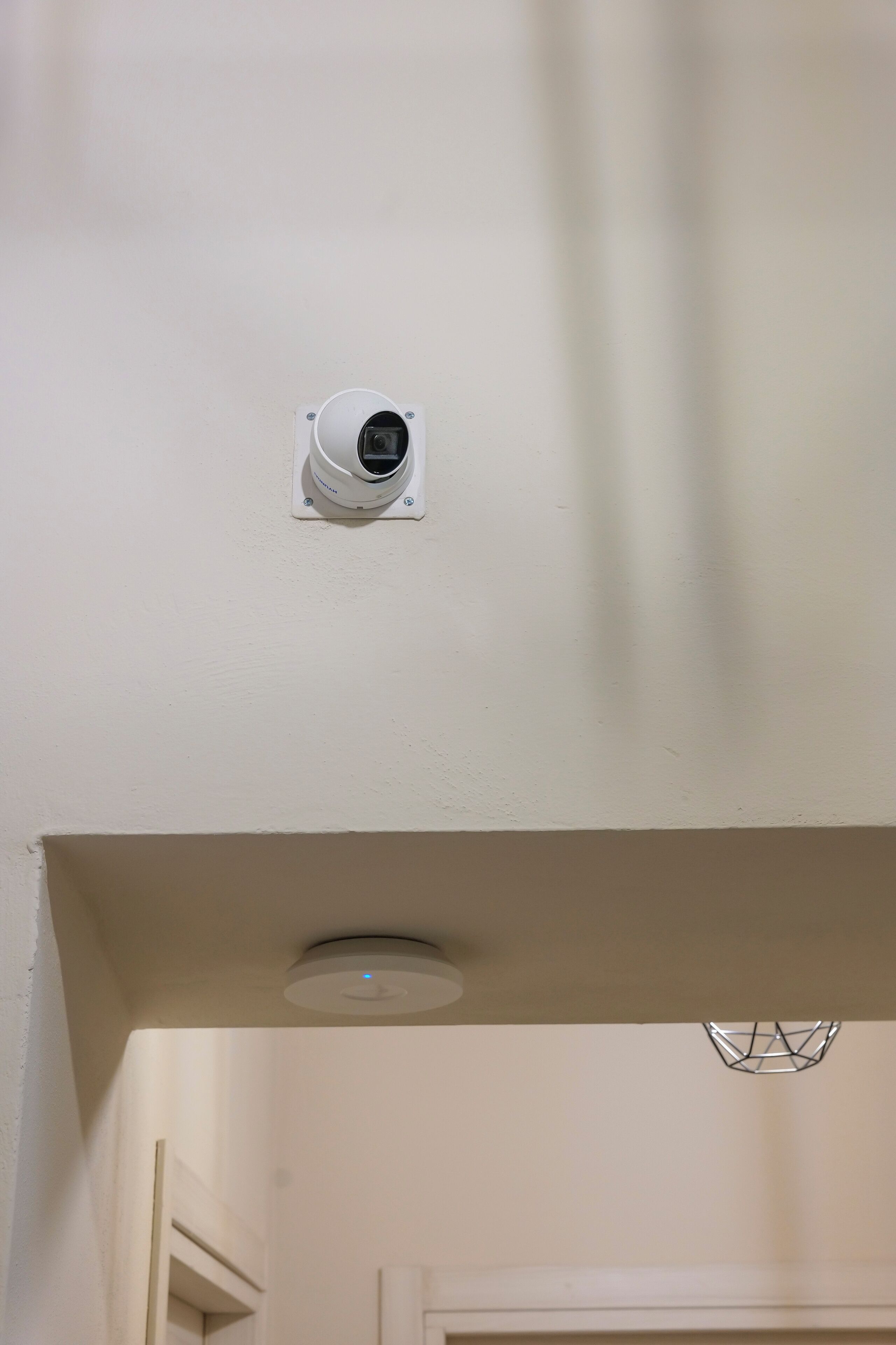 A ceiling-mounted security camera in a hallway.