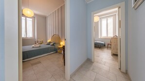 A bedroom with a bed, bedside table, lamp, and a window. - Apartment 'Villa Corallo - Acqua Marina' with Sea View, Wi-Fi and Air Conditioning (San Vincenzo)