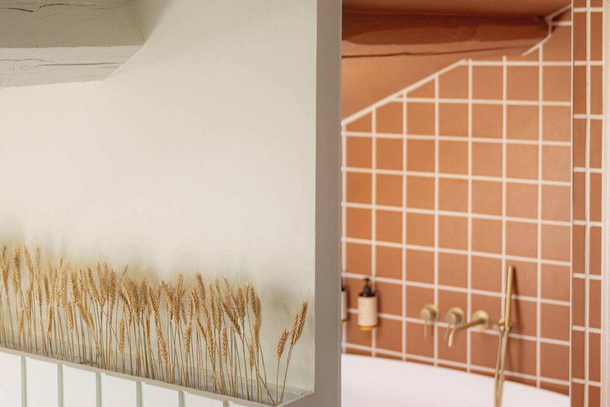 A modern bathroom with a white bathtub, a white sink, and a wall-mounted towel rack.