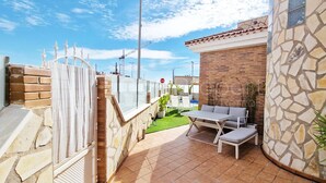 A patio area with a white table and bench, a brick wall, and a stone wall. - Beautiful and Peacefull 3 Bed Villa with Private Pool, AC (Avileses)