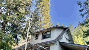 A two-story house with a covered garage and a balcony. - THE SPOT, EAST SHORE (Westwood)