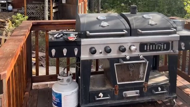 A barbecue grill with a gas tank on a wooden deck. - THE SPOT, EAST SHORE (Westwood)