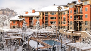 A snow-covered resort with multiple buildings, a pool area, and outdoor seating. - Welcome to Your 4BR/4BA Perfect Mountain Retreat in Park City (Park City)