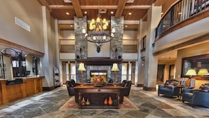 A spacious lobby with a stone fireplace, a chandelier, and a reception desk. - Welcome to Your 4BR/4BA Perfect Mountain Retreat in Park City (Park City)