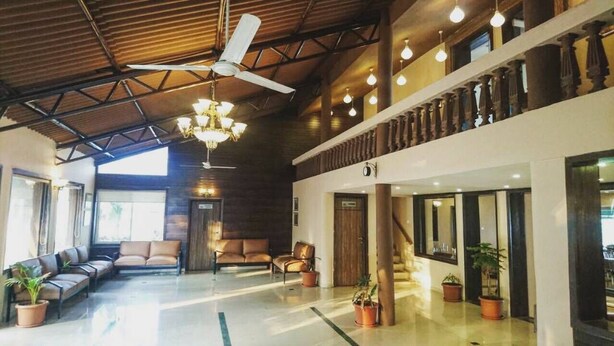 A spacious lobby with a high ceiling, a chandelier, and multiple seating areas. - Presidency Highland Resort (Patan)