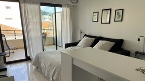 A modern bedroom with a bed, a desk, and a chair. There are three framed pictures on the wall. - Fully equipped studio in the center of Cannes with swimming pool, large terrace and air conditioning  (Cannes)