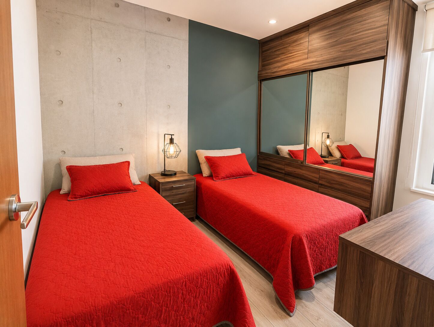 A bedroom with two beds, a nightstand, a mirror, and a wooden dresser.