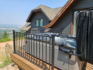 A cabin with a deck, a hot tub, and a view of the landscape. - Castle in the Sky- Overlooking Rapid City (Rapid City)