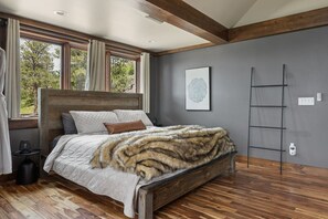 A bedroom with a wooden bed, a fur throw, and a ladder against the wall. - Castle in the Sky- Overlooking Rapid City (Rapid City)