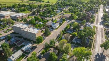 A residential area with a large building, likely a school or community center, surrounded by houses and streets.