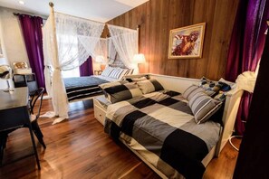 A bedroom with a four-poster bed, a daybed, and a desk with a chair. - Roomquest Rimrabeang Amphawa Floating Market (Amphawa)