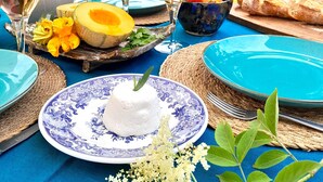 A table set for a meal with plates, glasses, and a bowl of fruit. - Beautiful country house at the entrance to the Crozon peninsula (Rosnoën)