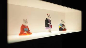 Three figurines on a shelf.