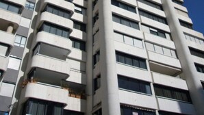A tall, modern high-rise building with multiple balconies and a clear blue sky in the background. - PARQUE EUROPA (1 BEDROOM) (Benidorm)