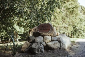 A sign with directions to 'HOUSE' and 'THE SHED'.
