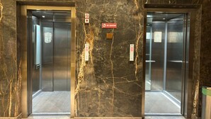 Two elevator doors with marble walls and a 'No Smoking' sign. - Shelter Suites (Formerly known as Fisco The Hub Link) (Mumbai)