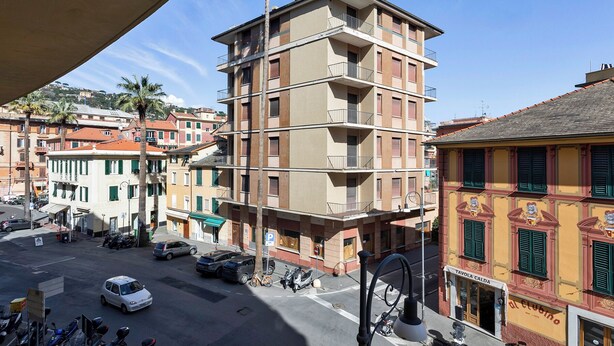 A multi-story building with balconies, a street view, and parked vehicles. - Large Apartment in the Heart of Santa Margherita Ligure by Wonderful Italy (Santa Margherita Ligure)