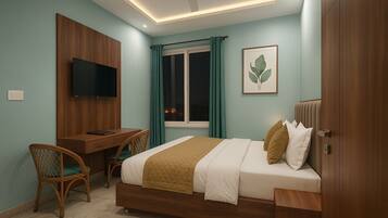 A bedroom with a bed, desk, chair, TV, and a window with curtains.