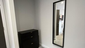 A room with a black dresser, a large mirror, and a carpeted floor. - 5 Star Brand New Liverpool City Centre Apartment (Liverpool)