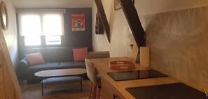 Cozy living space with a kitchenette, dining area, and sofa.