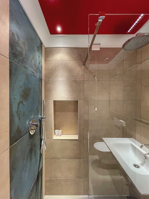 A modern bathroom with a shower, a bathtub, and a shelf with toiletries. - Beautiful Superior Room, elegant and refined in the heart of San Gimignano.  (San Gimignano)