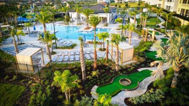 A resort with a swimming pool, palm trees, and a golf course. - CG 1407 Rolling Fairway Rolling Skies Poolside Cinema Spa Near Disney (Davenport)