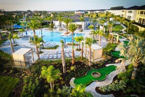 A resort with a swimming pool, palm trees, and a golf course. - CG 1407 Rolling Fairway Rolling Skies Poolside Cinema Spa Near Disney (Davenport)