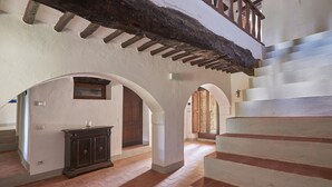 A spacious hallway with a staircase, wooden door, and a cabinet. - Podere Gabbiano, Castellina in Chianti, Siena and Chianti (Castellina in Chianti)
