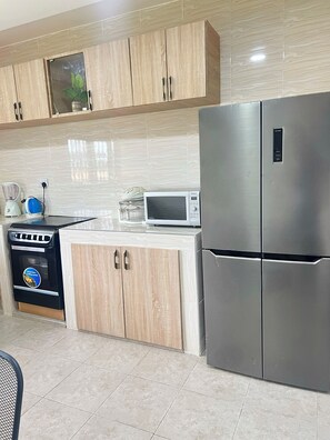 Full-sized fridge, microwave, rice cooker, cookware/dishes/utensils - ES Homes-2Bedroom Apartment at Achimota (Accra)