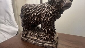 A sculpture of a horned animal on a wooden base. - 'Mac' in ApartNest ApartHotel (Auchterarder)