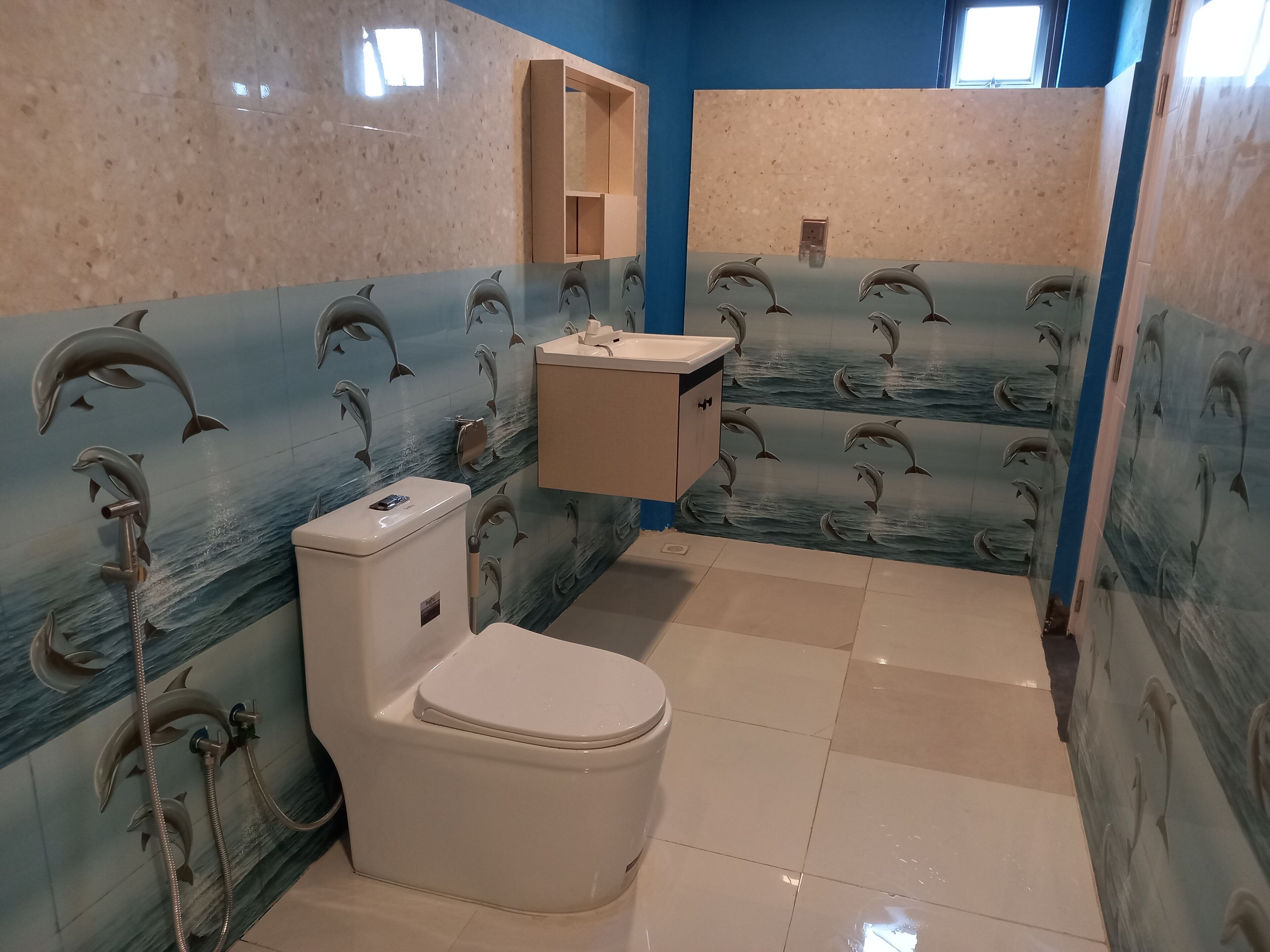 A bathroom with a toilet, sink, and shower area.