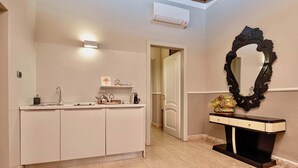 A bathroom with a white vanity, a black mirror, and a beige floor. - Palazzo Cavalli - Deco' (Verona)