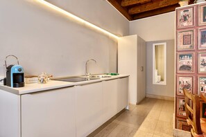 Fridge, dishwasher, coffee/tea maker, cookware/dishes/utensils