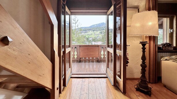 A wooden staircase leading to a balcony with a view of a green landscape. - Classy 3 bedroom few steps from centre (Cortina d'Ampezzo)
