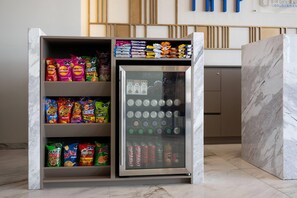 A snack vending machine with various chips and canned beverages.